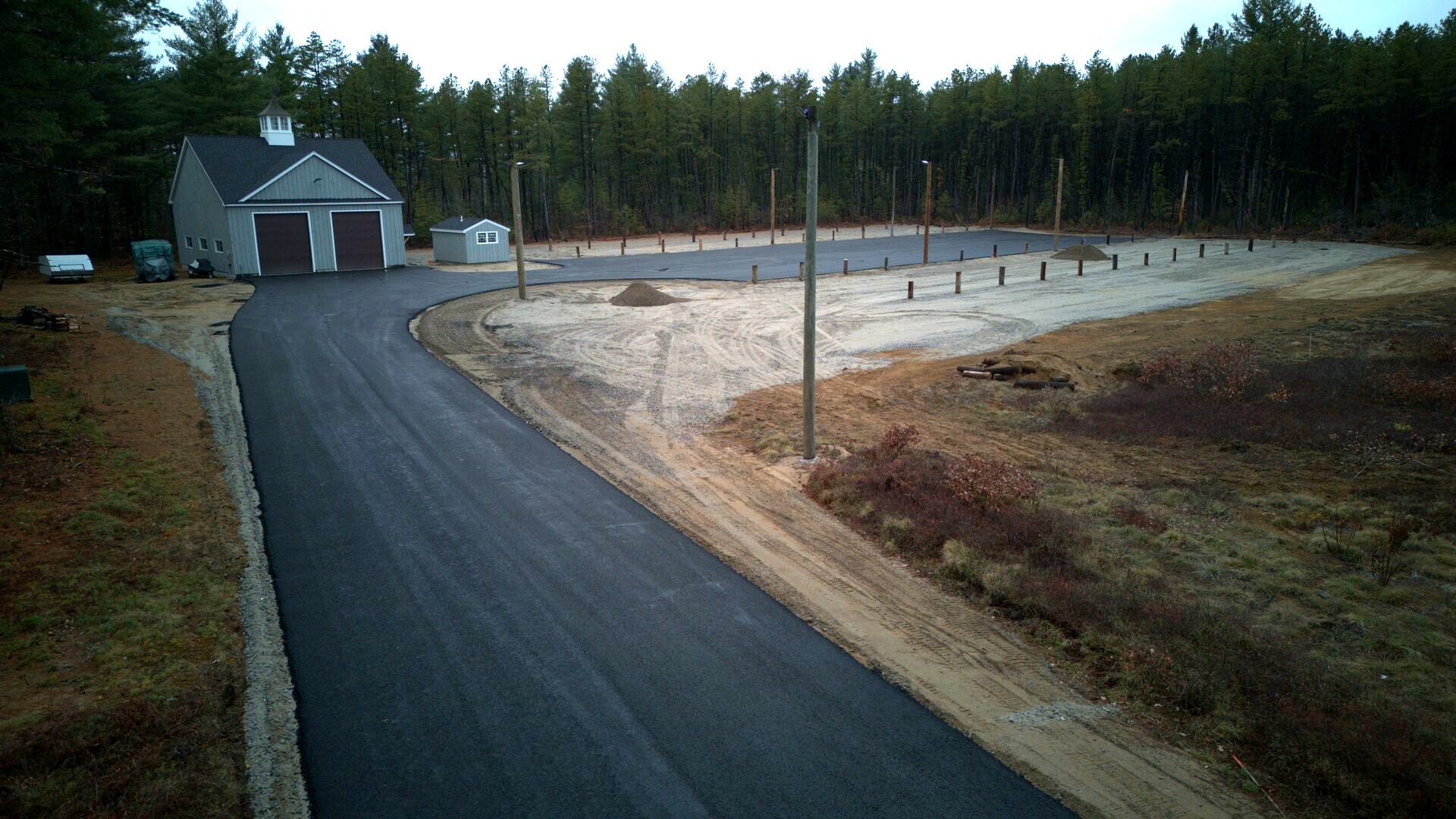 Northland Truck Parking facility - aerial view of barn-style building with paved driveway and parking lot